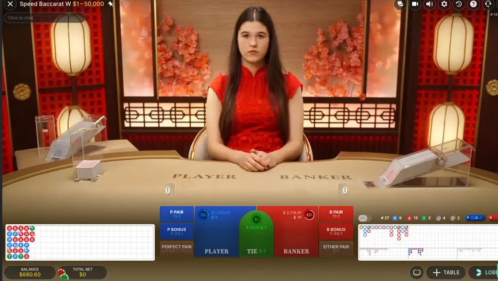 Live baccarat table in modern studio with female dealer and scoreboards