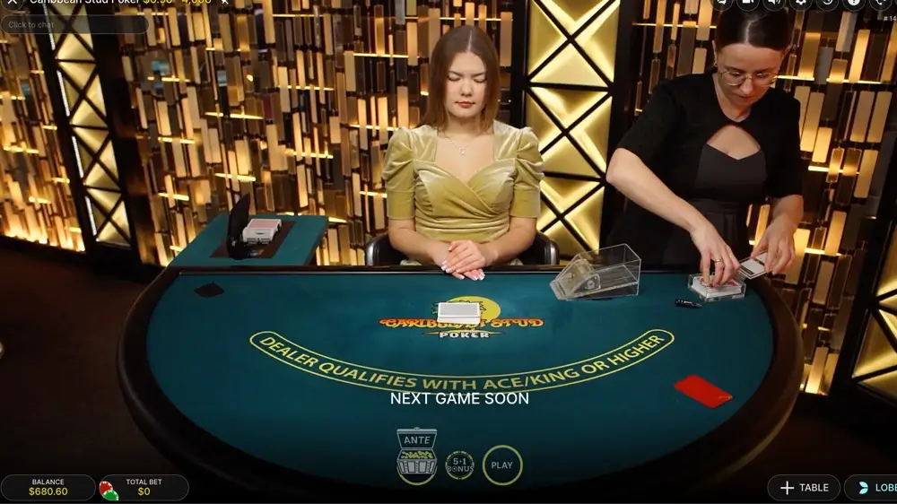 Live casino poker table with dealer preparing cards for the next hand